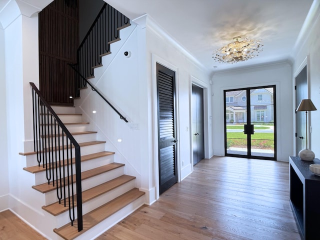 83 Norman Ct, Inlet Beach, FL 32461 - entryway with stairs, wood finished floors, crown molding, and a chandelier