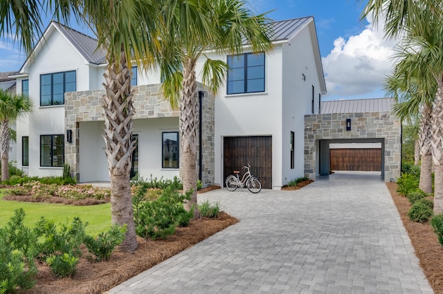83 Norman Ct, Inlet Beach, FL 32461 - contemporary house featuring stone siding, stucco siding, a metal roof, decorative driveway, and a standing seam roof