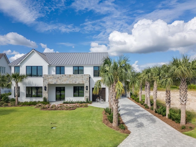83 Norman Ct, Inlet Beach, FL 32461 - contemporary home with stucco siding, stone siding, a front yard, and decorative driveway