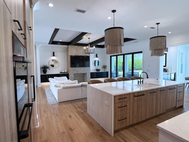 83 Norman Ct, Inlet Beach, FL 32461 - kitchen with modern cabinets, light brown cabinets, a large island with sink, beam ceiling, and recessed lighting