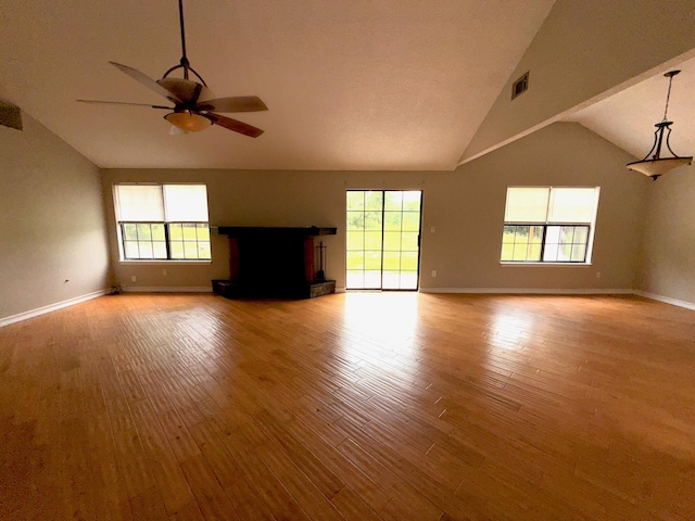7167 Manatee St, Navarre, FL 32566 - unfurnished living room featuring ceiling fan, wood finished floors, and high vaulted ceiling