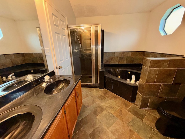 7167 Manatee St, Navarre, FL 32566 - bathroom featuring a shower stall, stone tile flooring, a whirlpool tub, and double vanity
