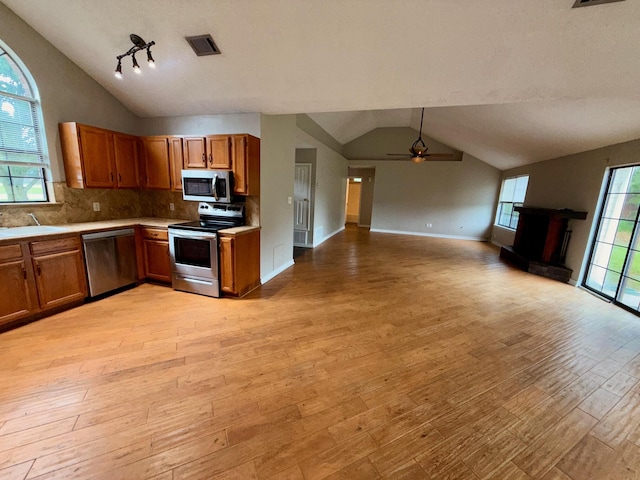 7167 Manatee St, Navarre, FL 32566 - kitchen featuring stainless steel appliances, lofted ceiling, light countertops, a ceiling fan, and light wood finished floors