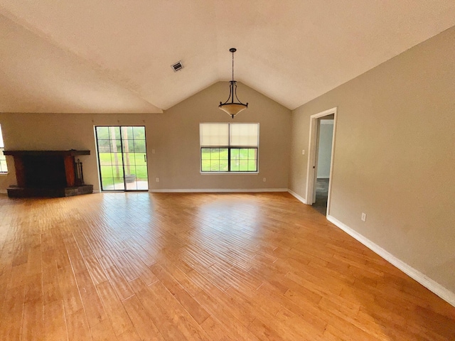 7167 Manatee St, Navarre, FL 32566 - unfurnished living room featuring light wood-style flooring and vaulted ceiling