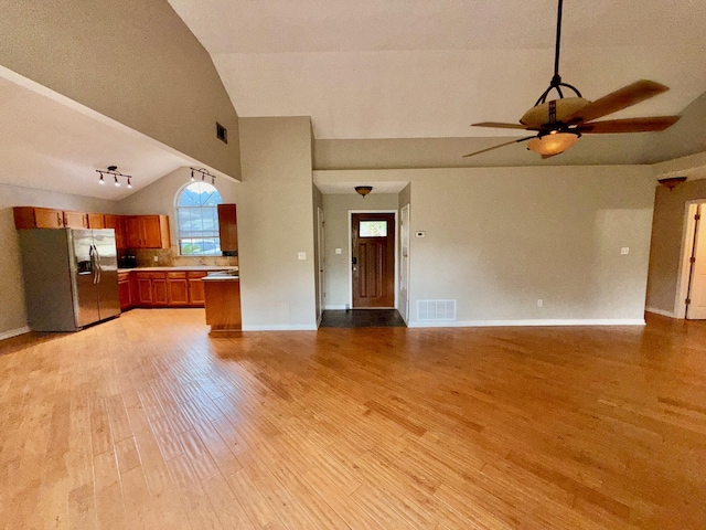 7167 Manatee St, Navarre, FL 32566 - unfurnished living room featuring ceiling fan, light wood finished floors, and high vaulted ceiling