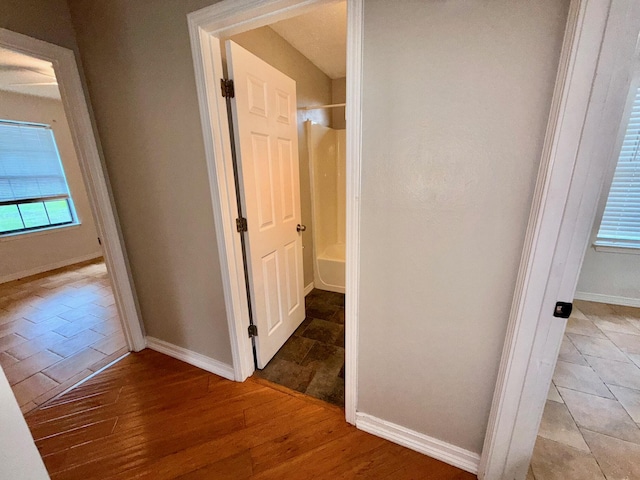 7167 Manatee St, Navarre, FL 32566 - hallway with baseboards and light wood-style floors