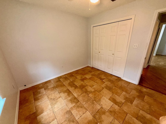 7167 Manatee St, Navarre, FL 32566 - unfurnished bedroom with stone finish floors, a closet, and ceiling fan