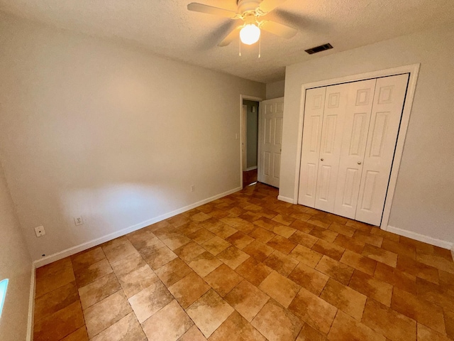 7167 Manatee St, Navarre, FL 32566 - unfurnished bedroom with a textured ceiling, a closet, and a ceiling fan
