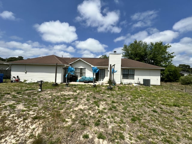 7167 Manatee St, Navarre, FL 32566 - back of house with an outdoor living space, a chimney, and a patio