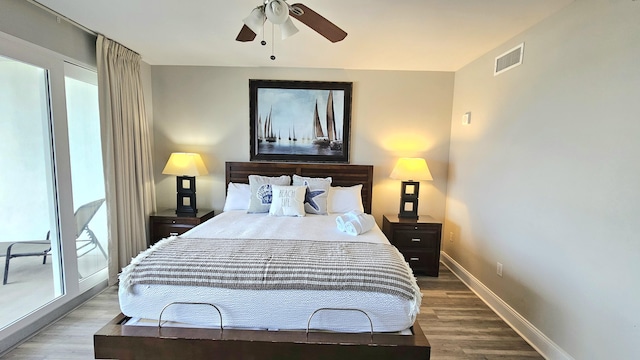 9902 S Thomas Dr Unit 933, Panama City Beach, FL 32408 - bedroom with wood finished floors, multiple windows, and a ceiling fan