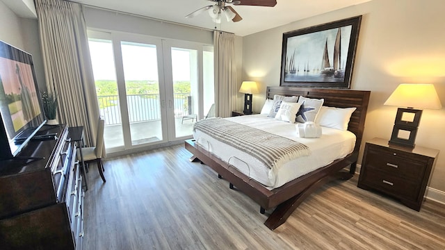 9902 S Thomas Dr Unit 933, Panama City Beach, FL 32408 - bedroom featuring access to outside, wood finished floors, french doors, and a ceiling fan