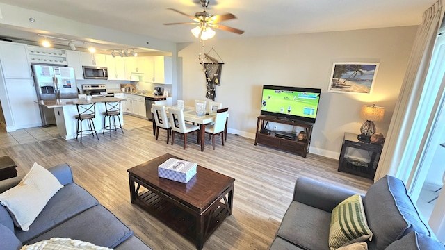 9902 S Thomas Dr Unit 933, Panama City Beach, FL 32408 - living area featuring light wood-type flooring, track lighting, and ceiling fan
