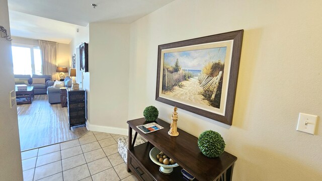 9902 S Thomas Dr Unit 933, Panama City Beach, FL 32408 - hallway featuring light tile patterned floors and baseboards