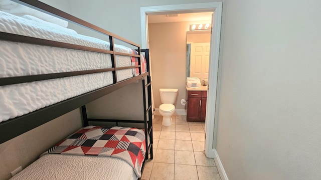 9902 S Thomas Dr Unit 933, Panama City Beach, FL 32408 - bedroom with light tile patterned flooring and ensuite bathroom