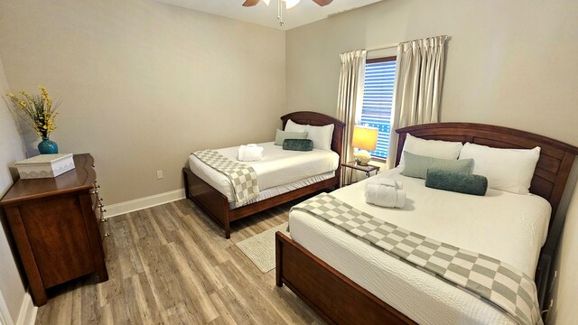 9902 S Thomas Dr Unit 933, Panama City Beach, FL 32408 - bedroom featuring light wood-style flooring and a ceiling fan