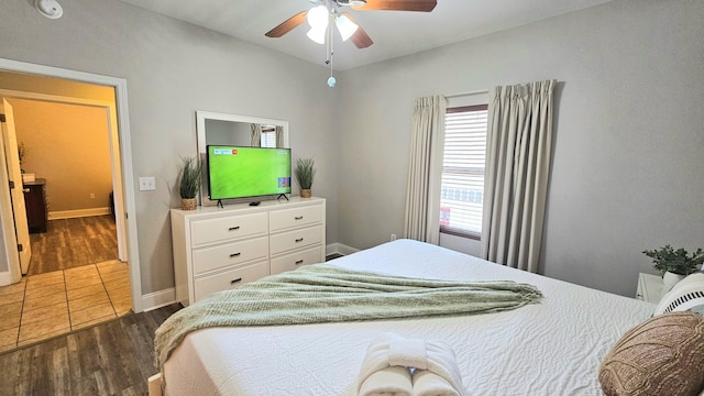 9902 S Thomas Dr Unit 933, Panama City Beach, FL 32408 - bedroom featuring dark wood finished floors and ceiling fan