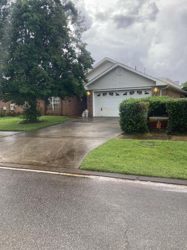 4627 Windstarr Dr, Destin, FL 32541 - view of front of property with driveway, a front yard, a garage, and brick siding