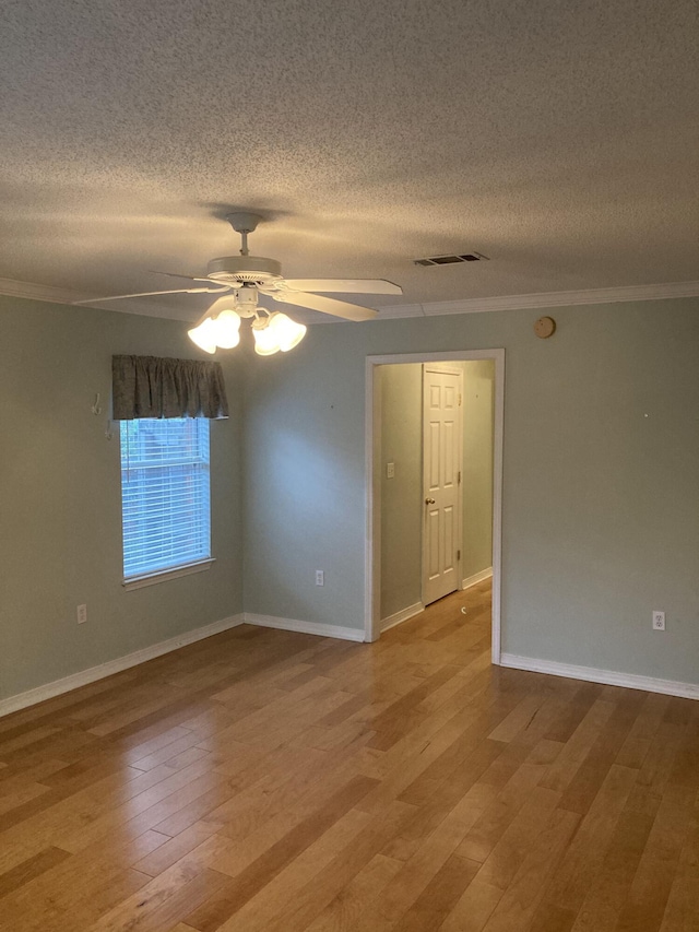 4627 Windstarr Dr, Destin, FL 32541 - spare room with ceiling fan, a textured ceiling, crown molding, light wood-style floors, and a smoke detector