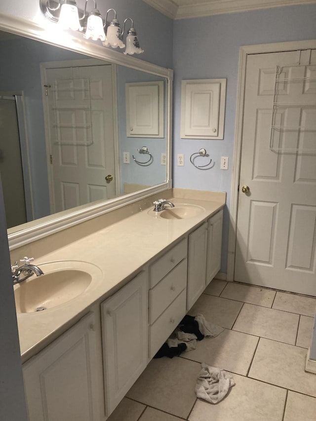 4627 Windstarr Dr, Destin, FL 32541 - bathroom with ornamental molding, double vanity, tile patterned floors, and a shower with door