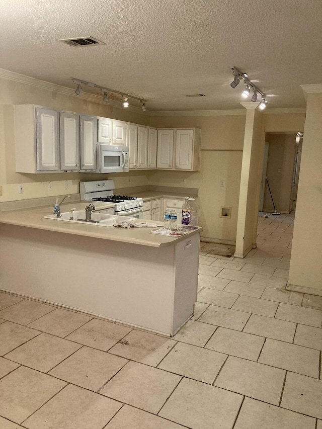 4627 Windstarr Dr, Destin, FL 32541 - kitchen featuring track lighting, white appliances, crown molding, a peninsula, and a textured ceiling