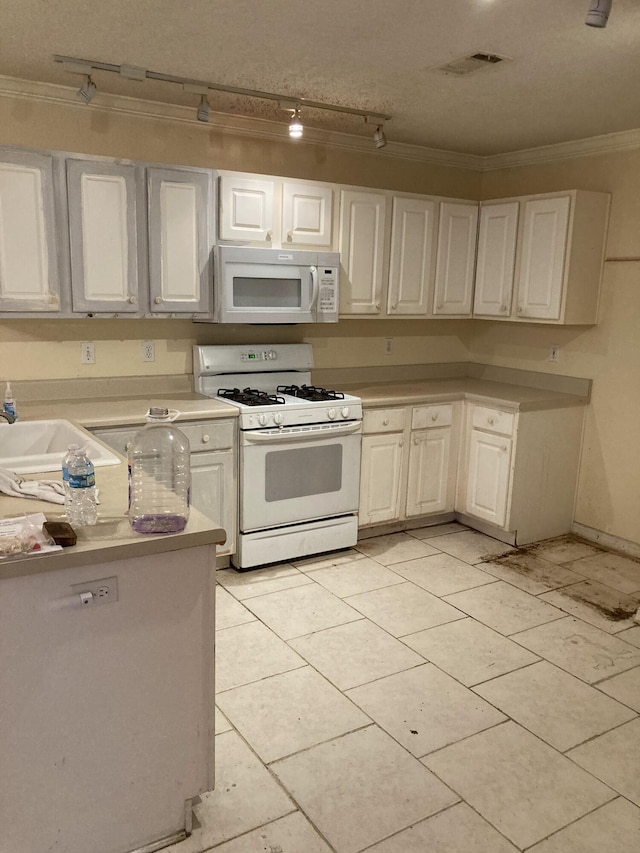 4627 Windstarr Dr, Destin, FL 32541 - kitchen with white appliances, ornamental molding, light countertops, light tile patterned floors, and white cabinetry