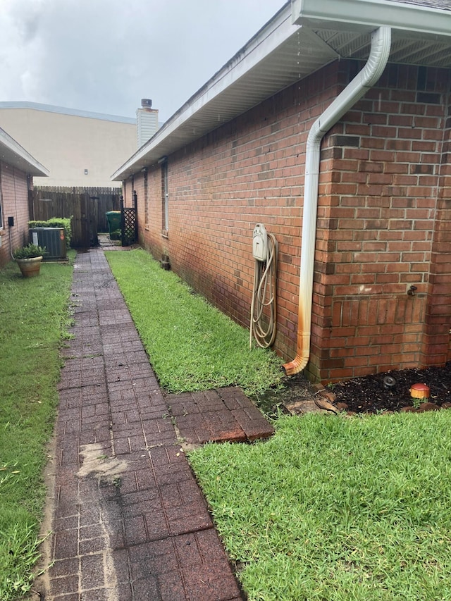 4627 Windstarr Dr, Destin, FL 32541 - view of side of property with a chimney and brick siding