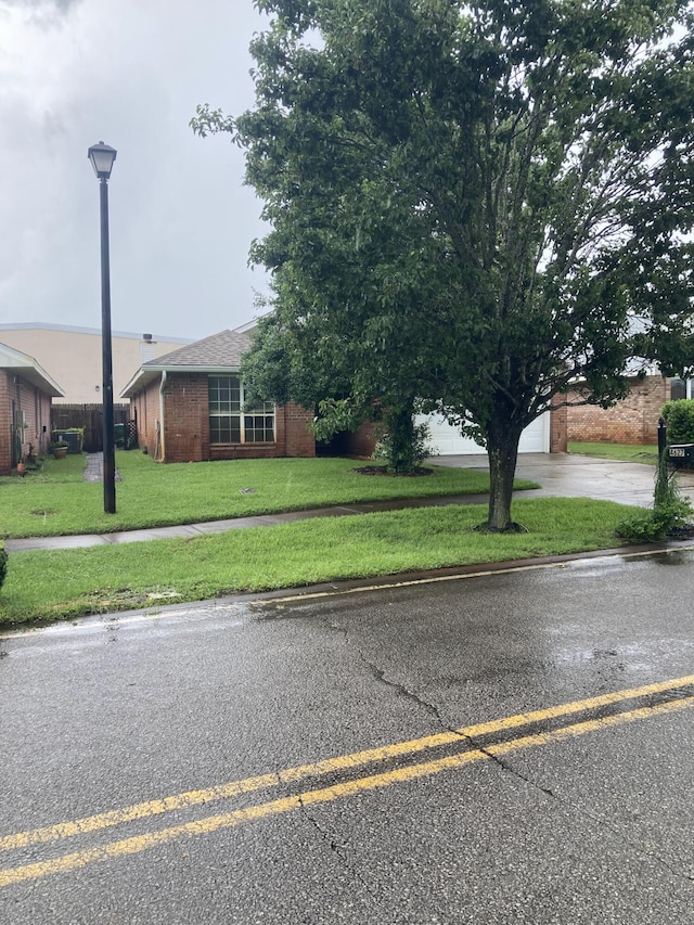 4627 Windstarr Dr, Destin, FL 32541 - view of front facade featuring brick siding, a front lawn, and concrete driveway