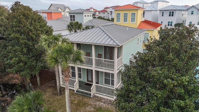 54 Rue Du Soleil, Santa Rosa Beach, FL 32459 - rear view of property featuring a metal roof, a standing seam roof, a residential view, and a balcony