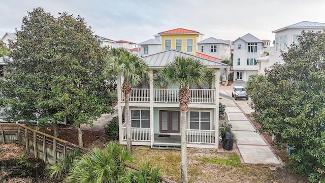54 Rue Du Soleil, Santa Rosa Beach, FL 32459 - rear view of property with a standing seam roof, a metal roof, a balcony, a residential view, and french doors