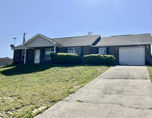 5151 Eagle Way, Crestview, FL 32539 - ranch-style home featuring driveway, a garage, a front yard, and brick siding