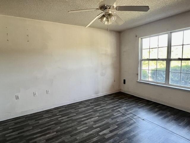 5151 Eagle Way, Crestview, FL 32539 - empty room with dark wood-type flooring, a textured ceiling, and ceiling fan