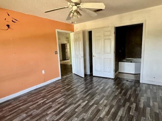 5151 Eagle Way, Crestview, FL 32539 - unfurnished bedroom featuring dark wood-style floors, a textured ceiling, and a ceiling fan