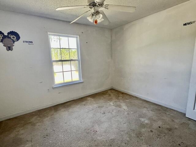 5151 Eagle Way, Crestview, FL 32539 - unfurnished room featuring a textured ceiling, carpet floors, and ceiling fan