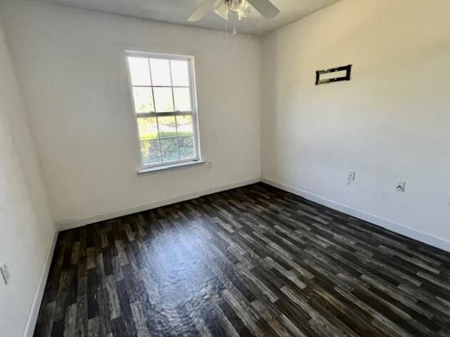 5151 Eagle Way, Crestview, FL 32539 - spare room featuring a ceiling fan and dark wood-style flooring