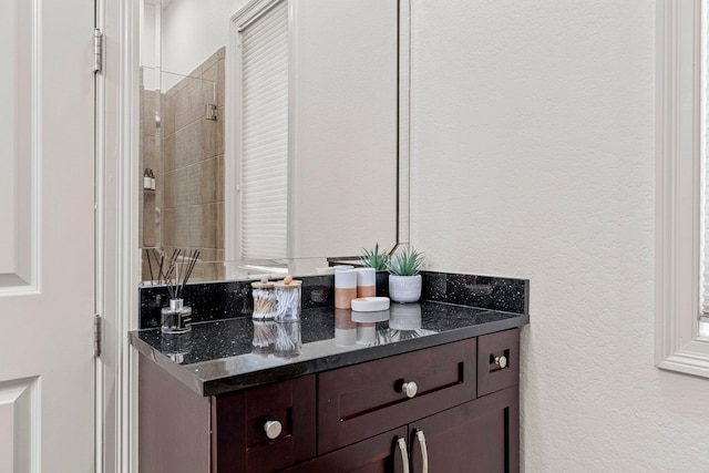 37 Conch Cay, Destin, FL 32541 - bathroom featuring vanity, a textured wall, and a tile shower