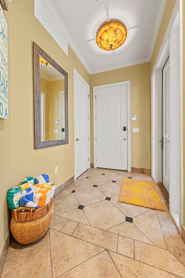 37 Conch Cay, Destin, FL 32541 - foyer featuring ornamental molding and inlaid floor details