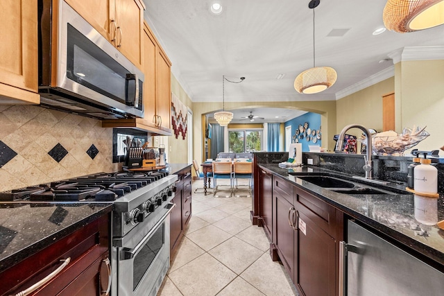 37 Conch Cay, Destin, FL 32541 - kitchen featuring stainless steel appliances, ornamental molding, backsplash, pendant lighting, and dark stone counters