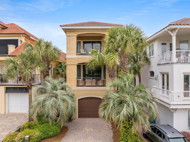 37 Conch Cay, Destin, FL 32541 - view of front of home with stucco siding, a garage, decorative driveway, and a balcony
