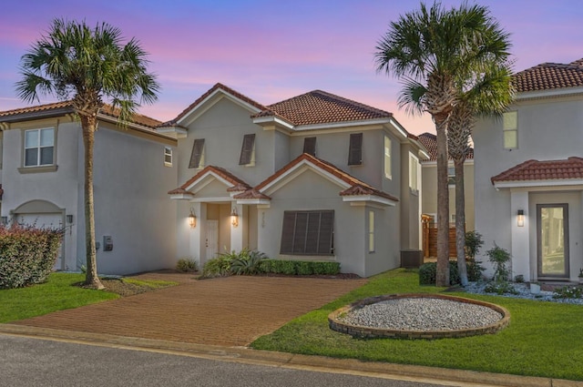 4739 Amhurst Cir, Destin, FL 32541 - mediterranean / spanish home with a tiled roof, stucco siding, a yard, and decorative driveway