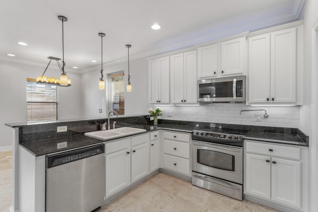 4739 Amhurst Cir, Destin, FL 32541 - kitchen featuring stainless steel appliances, a peninsula, white cabinetry, ornamental molding, and recessed lighting