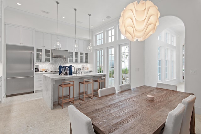 37 Sugar Loaf Aly, Alys Beach, FL 32461 - dining room with arched walkways, crown molding, and recessed lighting