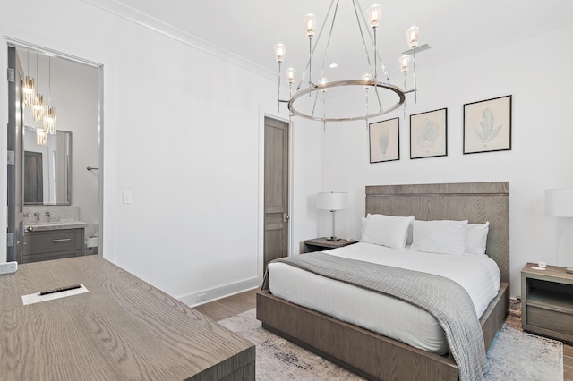 37 Sugar Loaf Aly, Alys Beach, FL 32461 - bedroom with a chandelier, wood finished floors, ensuite bath, and ornamental molding