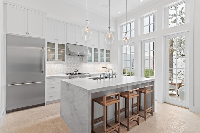 37 Sugar Loaf Aly, Alys Beach, FL 32461 - kitchen with built in refrigerator, under cabinet range hood, healthy amount of natural light, decorative backsplash, and recessed lighting