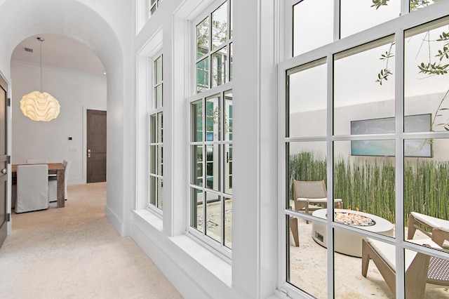 37 Sugar Loaf Aly, Alys Beach, FL 32461 - hallway featuring arched walkways, a towering ceiling, crown molding, carpet floors, and a chandelier