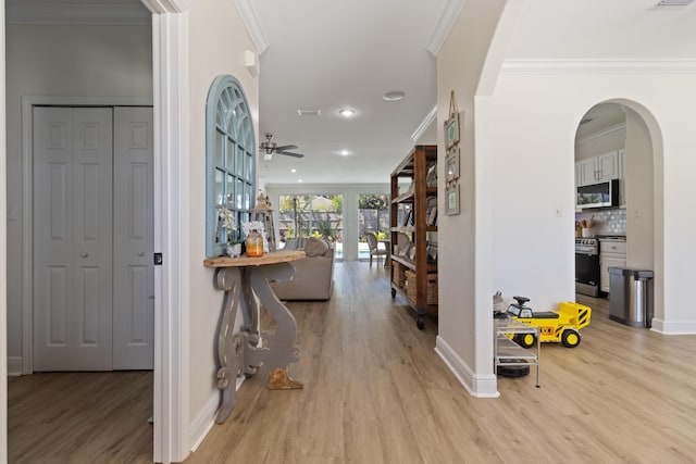 1009 Forest Shore Dr, Miramar Beach, FL 32550 - hall with wood finished floors, ornamental molding, arched walkways, and recessed lighting