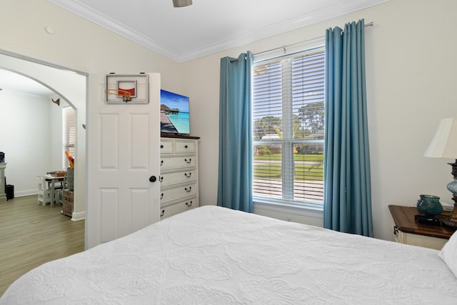 1009 Forest Shore Dr, Miramar Beach, FL 32550 - bedroom with arched walkways, crown molding, wood finished floors, and a ceiling fan