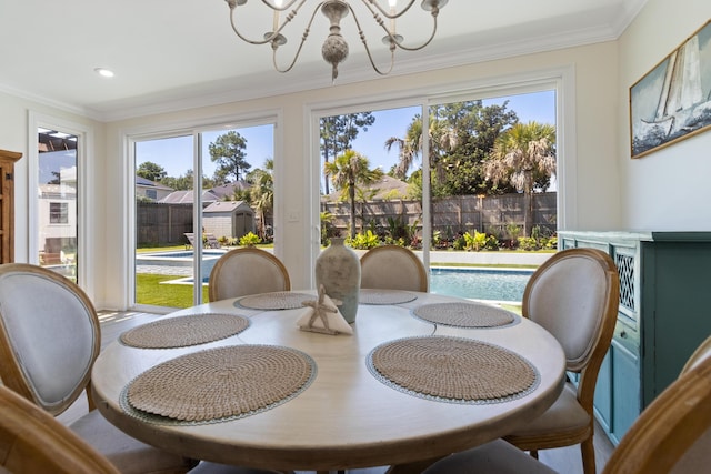 1009 Forest Shore Dr, Miramar Beach, FL 32550 - dining area with a chandelier, ornamental molding, and healthy amount of natural light