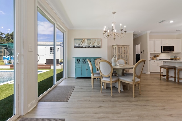 1009 Forest Shore Dr, Miramar Beach, FL 32550 - dining area featuring a chandelier, crown molding, light wood-style flooring, and recessed lighting