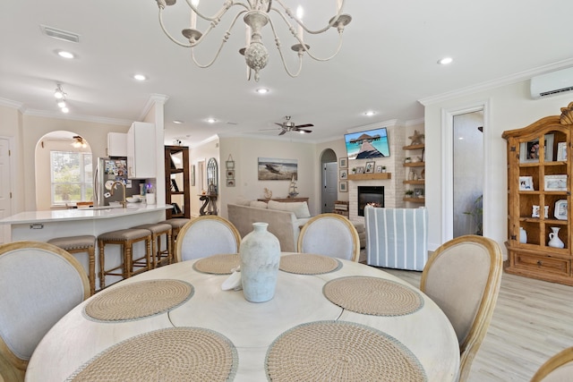 1009 Forest Shore Dr, Miramar Beach, FL 32550 - dining space with arched walkways, ornamental molding, a wall unit AC, a chandelier, and recessed lighting