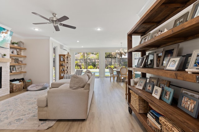 1009 Forest Shore Dr, Miramar Beach, FL 32550 - living room with a chandelier, wood finished floors, a fireplace, ceiling fan, and crown molding